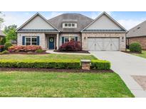 Charming brick home featuring a manicured lawn, blue shutters, and a welcoming front porch at 4815 Amble Trce, Cumming, GA 30040