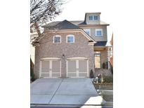 Charming two-story brick home with a two-car garage and inviting front entrance at 548 Myrtle Trace Ln, Suwanee, GA 30024
