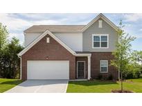 Charming two-story home with a brick facade, two-car garage, and well-manicured lawn at 2389 Argento Cir, Dacula, GA 30019