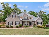 Charming brick home with manicured lawn and mature trees in a desirable neighborhood at 2920 Stanway Ave, Douglasville, GA 30135