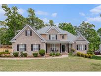 Charming brick home featuring a manicured lawn and inviting front porch at 2920 Stanway Ave, Douglasville, GA 30135
