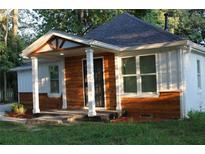 Charming renovated home featuring a welcoming front porch and wood-accented siding at 2040 Penelope Nw St, Atlanta, GA 30314