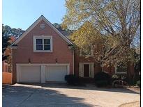 Charming two-story brick home with a two-car garage and well-manicured landscaping at 4746 Chamblee Dunwoody Rd, Atlanta, GA 30338