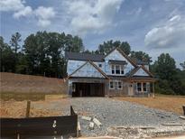 New construction home featuring a modern design with a covered porch and a two-car garage at 294 Pickens Bluff Ln, Hiram, GA 30141