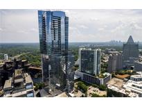 Stunning aerial view showcasing the modern high-rise building with city skyline and lush green landscape at 3344 Peachtree Ne Rd # 3601, Atlanta, GA 30326