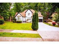 Charming two-story home with well-maintained lawn and a dark-colored attached garage at 6147 Pritchett Dr, Powder Springs, GA 30127