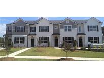 New townhomes showcasing painted brick, siding accents, manicured lawns, and individual front entrances at 460 Reflection Dr # 21, Stockbridge, GA 30281