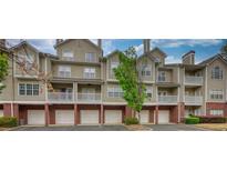 Attractive condo exterior showcasing brick accents and multiple stories with individual garages at 3107 Woodland Ln, Alpharetta, GA 30009