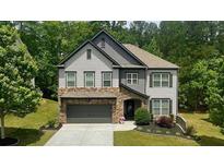 Charming two-story home with stone accents and meticulously manicured landscaping at 109 Red Fox Dr, Dallas, GA 30157