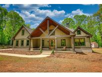Charming craftsman-style home with a welcoming front porch and attractive wooden design elements at 60 Browning Shoals Rd, Social Circle, GA 30025