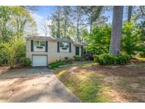 Charming single-story home with a well-maintained lawn and a one-car garage at 723 Monticello Se Way, Marietta, GA 30067