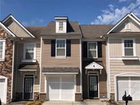 Charming townhouse with a one-car garage, contrasting trim and beautiful architectural detail at 1938 Dilcrest Dr, Duluth, GA 30096
