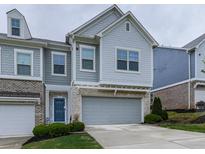 Charming two-story home with a brick and siding exterior, a two-car garage, and well-manicured landscaping at 130 Maple Creek Way, Woodstock, GA 30188