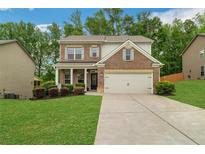 Charming two-story brick home with a well-manicured lawn and inviting curb appeal at 4240 Spring Ridge Dr, Cumming, GA 30028