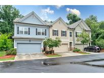 Charming townhome with multiple garages, landscaping, and neutral exterior paint colors at , Atlanta, GA 30316