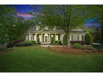 Charming single-Gathering home with well-manicured lawn, lush landscaping and inviting front porch at 5705 Twelve Oaks Dr, Cumming, GA 30028