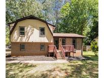 Inviting two-story home featuring a mix of brick and siding, complemented by a welcoming front porch and lush greenery at 240 Wellington Dr, Mcdonough, GA 30252