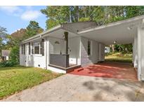 Charming single-story home featuring a convenient carport and covered front porch at 3406 Jackson Dr, Decatur, GA 30032