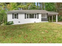Charming one-story home with freshly painted white brick and a spacious front yard at 3406 Jackson Dr, Decatur, GA 30032