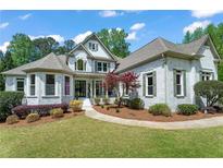 Charming painted brick home with well-manicured lawn and mature landscaping at 1749 Patriots Nw Way, Kennesaw, GA 30152