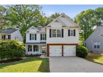 Charming two-story home with a well-manicured lawn and a two-car garage at 2332 Leacroft Way, Marietta, GA 30062