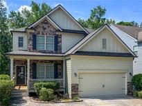 Charming two-story home with a combination of stone and shingle siding, complemented by a well-manicured front yard at 251 Shaw Dr, Acworth, GA 30102