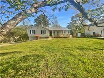 Charming home featuring a front porch, complemented by a well-maintained lawn at 294 Farm Ridge Ne Dr, Woodstock, GA 30188
