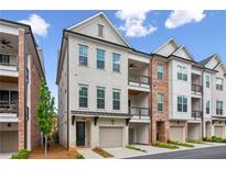 Modern townhouse with painted brick, private garage, covered entry, and balcony in a desirable location at 427 Burton Dr, Alpharetta, GA 30009