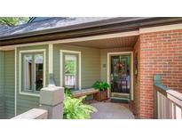 Charming covered entryway with decorative wreath, bench seating, and lush landscaping at 470 Ansley Walk Ne Ter, Atlanta, GA 30309