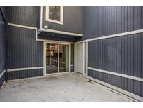 A cozy outdoor patio with a sliding door and a white door to enter into the house at 1022 Mariners Ct, Stone Mountain, GA 30083