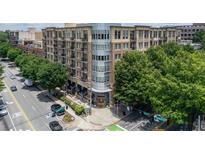 Beautiful condo building with street view, lush trees and manicured landscaping with upscale exterior and walkable sidewalks at 201 W Ponce De Leon Ave # 402, Decatur, GA 30030