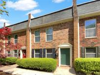 Charming brick townhouse featuring well-maintained landscaping and a welcoming front entrance at 165 N River Dr # B, Atlanta, GA 30350