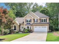Charming two-story traditional home with well-manicured lawn, two-car garage and lush landscaping at 989 Pinfeather Ct, Lawrenceville, GA 30043