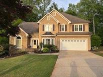 Charming two-story home with manicured lawn and two car garage at 989 Pinfeather Ct, Lawrenceville, GA 30043