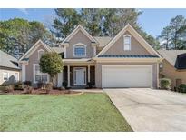 Charming home with a well-manicured lawn, a two-car garage, and a classic stucco facade at 3850 Laurel Nw Dr, Acworth, GA 30101