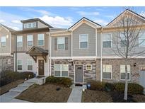 Charming townhome with stone accents, neutral siding, manicured lawn and easy to navigate front steps at 813 Ambient Sw Way, Atlanta, GA 30331