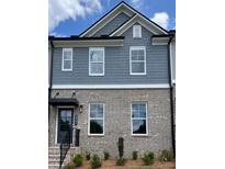 Charming townhome with brick and gray shingle exterior and well-maintained landscaping at 1262 Ainsworth Aly # 48, Sugar Hill, GA 30518