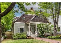 Charming craftsman-style home featuring a welcoming front porch, lush landscaping, and beautiful architectural details at 655 Moreland Se Ave, Atlanta, GA 30316