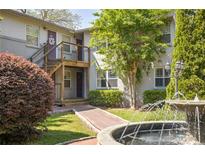 Apartment building featuring brick walkway, fountain, and lush landscaping at 24 Daniel Se St # 3, Atlanta, GA 30312