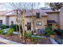 Charming townhome with a well-maintained front yard and neutral siding in a quiet neighborhood at 3812 Stonewall Se Ter, Atlanta, GA 30339