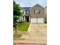 Charming two-story home with a brick facade and a well-maintained front yard at 573 Emporia Loop, Mcdonough, GA 30253