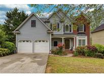 Charming two-story home featuring a two-car garage, well-maintained lawn, and attractive landscaping at 1533 Fallen Leaf Sw Dr, Marietta, GA 30064