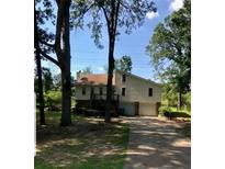 Two story home featuring a two car garage and a stairway leading to the front entrance at 6070 Ridge Way, Douglasville, GA 30135