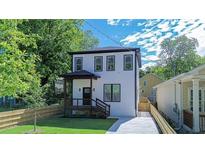 Charming two-story home with black trim, covered porch, and a well-maintained lawn at 1166 Mcdaniel Sw St, Atlanta, GA 30310