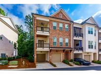 Charming brick townhome featuring a two-story facade and two balconies perfect for outdoor enjoyment at 451 Burton Dr # 32, Alpharetta, GA 30009