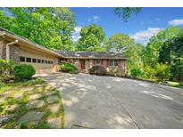 Charming single-story brick home with an attached garage, well-manicured lawn, and plenty of parking space at 659 Pleasant Hill Nw Rd, Conyers, GA 30012