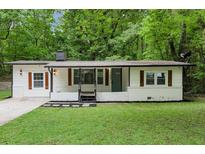 Charming renovated single-story home featuring updated landscaping, fresh exterior paint, and modern accents at 3458 Cooper St, Lithia Springs, GA 30122