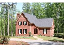 Charming brick home featuring a classic design, manicured landscaping, and a welcoming curved walkway at 349 Harris Loop, Dallas, GA 30157