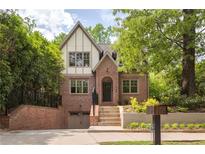 Charming brick two-story home featuring a gable roof, dormer windows, and a nicely landscaped front yard at 134 Woodlawn Ave, Decatur, GA 30030