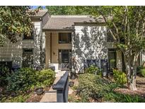 Exterior view of home with well-maintained landscaping and a walkway up to the front door at 11 Forrest Pl, Atlanta, GA 30328
